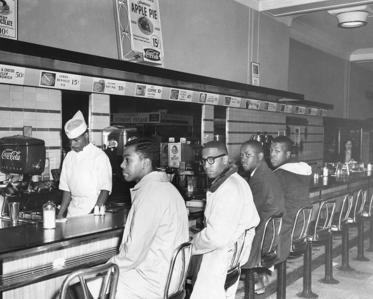 Second day of the sit in at F. W. Woolworth Company, February 2, 1960. From left: Joseph McNeil, Franklin McCain, Billy Smith, Clarence Henderson. Courtesy The News & Record