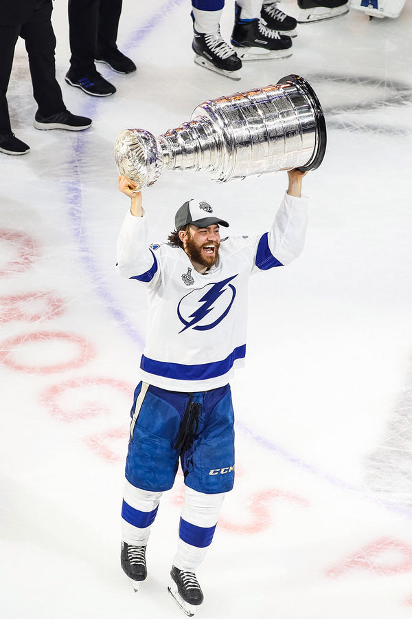 Tampa Bay Lightning center Brayden Point hoists the Stanley Cup following the Game 6 win against the Dallas Stars during the Stanley Cup final on Sept. 28, 2020, in Edmonton. Special to the Times / Mario Ditkun