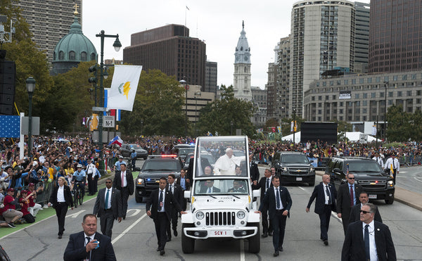 Pope Francis waves to the faithful as he travels up the Benjamin Franklin Parkway Septmeber 27, 2015 enroute to an outdoor papal mass. Clem Murray / Staff Photographer