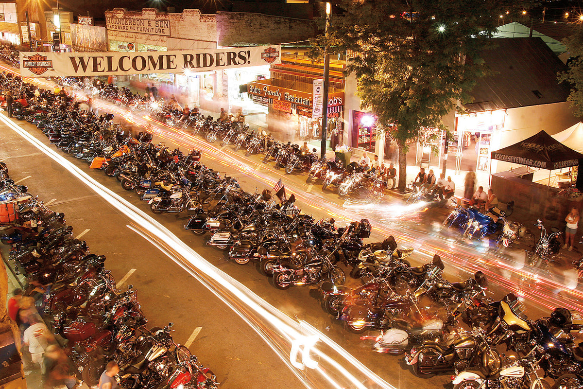 Bikes turn into light trails as they stream up and down Main Street just after sunset at the 2007 Sturgis rally.