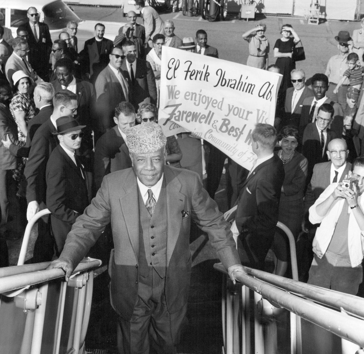President of Sudan, El Ferik Ibrahim Abboud, climbs the ramp to his air force Constellation after completing his Fresno visit. The air force plane took him on an aerial tour of San Joaquin Valley water projects on the flight to San Francisco. After a stop in New York, Abboud left on a flight to Africa. Courtesy The Fresno Bee