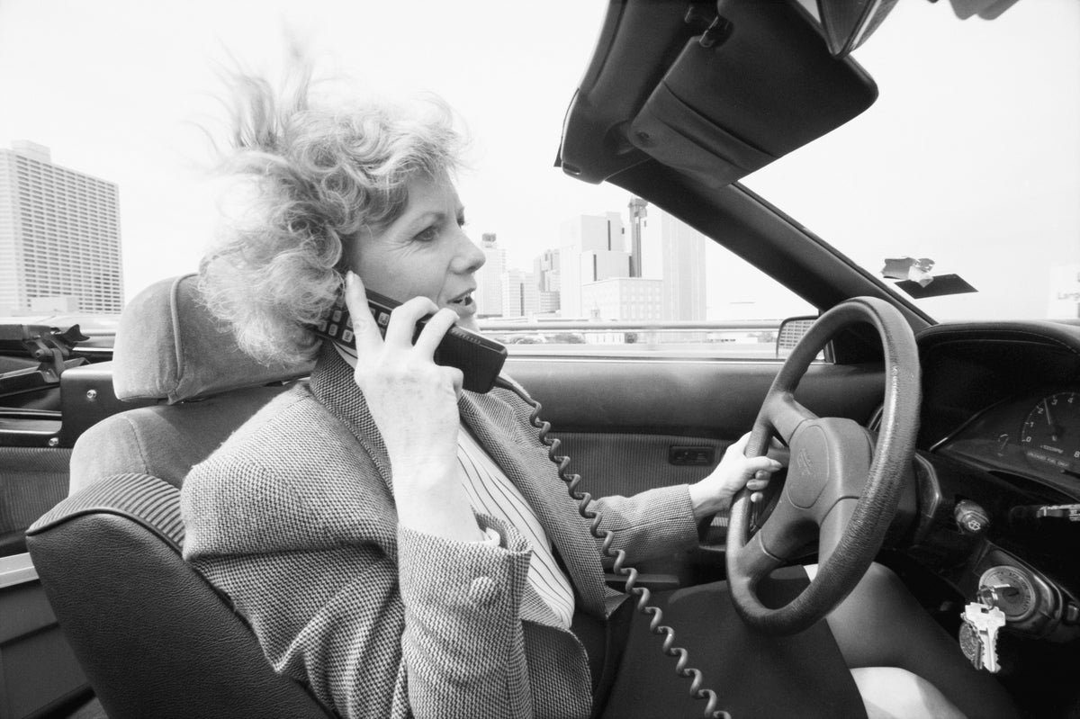 Newly elected Fort Worth Mayor Kay Granger, now on a 90-hour-a-week schedule, talking on her car phone while driving in her convertible Toyota Celica, May 19, 1991. Courtesy Fort Worth Star-Telegram Collection, Special Collections, UT Arlington Libraries; photo by Carolyn Bauman