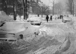 People walk down a street on Buffalo's West Side. In some areas, residents formed shovel brigades to clear streets that plows couldn't reach. Courtesy Richard W. Roeller/Buffalo News