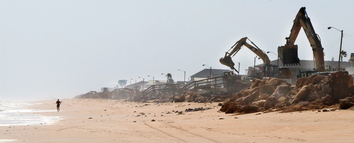 Heavy machinery works to clear rubble from State Road A1A in Flagler Beach. News-Journal/Jim Tiller
