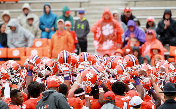 Members of the Clemson football team raise their helmets before leaving the field after warmups. Sefton Ipock / Anderson Independent Mail