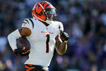 Cincinnati Bengals wide receiver Ja'Marr Chase (1) breaks tackles as he takes a reception 82 yards for a touchdown in the third quarter of the NFL Week 7 game between the Baltimore Ravens and the Cincinnati Bengals at M&T Bank Stadium in Baltimore on Sunday, Oct. 24, 2021. The Bengals moved into the top of the AFC North with a 41-17 win over the Ravens. Sam Greene/The Enquirer