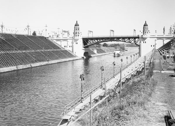 Bleachers are set up along the Montlake Cut next to the Montlake Bridge in advance of the Shrine Convention Marine Pageant on July 16, 1936. The parade on water featured floats that really floated. The bridge opened June 27, 1925. The distinctive Gothic control towers are intended to reflect the dominant architectural forms of the nearby University of Washington campus. Courtesy Seattle Municipal Archives