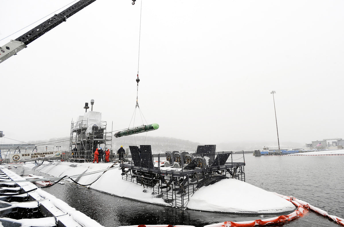 A MK 48 ADCAP torpedo is unloaded from the fast-attack submarine USS Annapolis (SSN-760) by sailors from the weapons department during a snowstorm on January 15, 2009. Courtesy U.S. Navy Photo