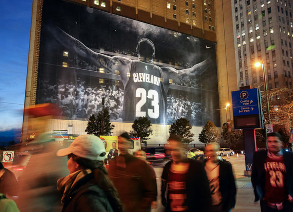 Cavaliers fans pass the new LeBron James mural across the street from Quicken Loans Arena prior to the 2014–15 home opener against New York. Lisa DeJong / The Plain Dealer