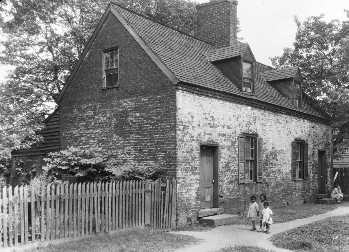 Three children in front of a cabin on Water Street, circa 1928. Courtesy Library of Congress