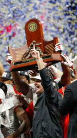 Georgia head coach Kirby Smart and his team raise the SEC Championship trophy after winning the SEC Championship game over Auburn in Atlanta, Dec. 2, 2017. Georgia won 28-7. Joshua L. Jones, Athens Banner-Herald