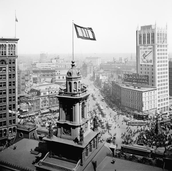 The cupola of Old City Hall at Woodward and Michigan Avenues rises above the bustling streets below. At right a billboard encourages people to buy Liberty Bonds to support the war. Courtesy The Detroit News