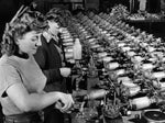 Workers in a munitions factory assemble parts for radio-controlled bombs, Dec. 29, 1944. The Detroit News