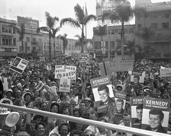 Crowds gather at Horton Plaza as Senator John F. Kennedy gives a speech in front of the U.S. Grant Hotel during a campaign visit to San Diego on November 2, 1960, six days before the election. In his speech, JFK said San Diego had twice as many unemployed as in 1959 and “the Republicans don’t care.” Union-Tribune, photo by Thane McIntosh