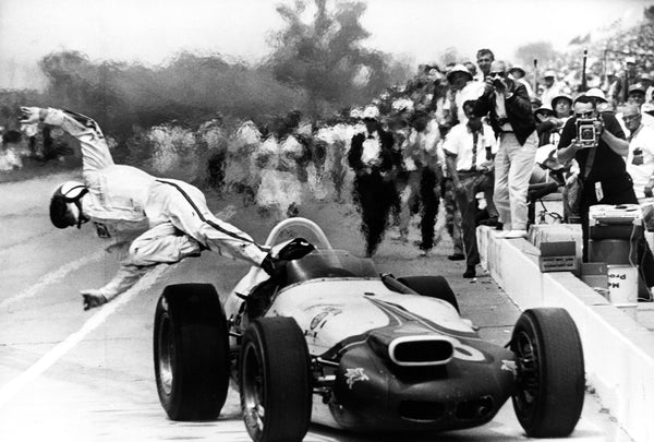 Parnelli Jones leaps from his race car as it coasts to a stop after it caught fire during a pit stop in the 1964 500. Jones was not hurt. Indianapolis Star photographer Frank Fisse photographed Parnelli Jones jumping from his race car after it caught fire during a pit stop in the 1964 500. Jones was not hurt, but his incident was overshadowed by a boiling inferno on the second lap that killed Eddie Sachs and Dave McDonald.