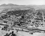 Aerial view of downtown Las Vegas, circa 1960. Fremont Street, also known as Glitter Gulch, is at the center of the photo and ends at the Union Pacific Railroad depot (visible just left of center), which was the future site of the Union Plaza Hotel and Casino. Courtesy Nevada State Museum, Las Vegas