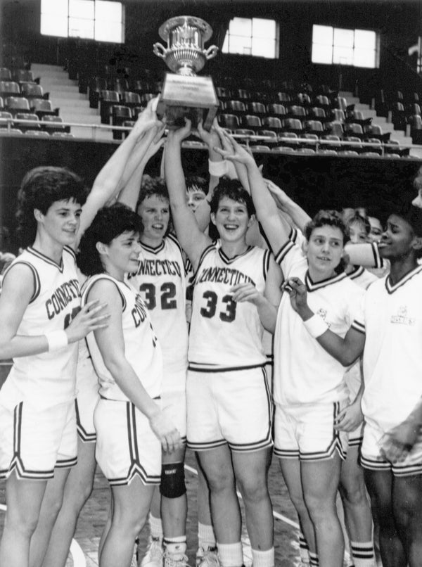 Players hoist the team trophy after winning the 1991 Big East tournament championship with a 79-74 win over Providence at Georgetown University. UConn Photo