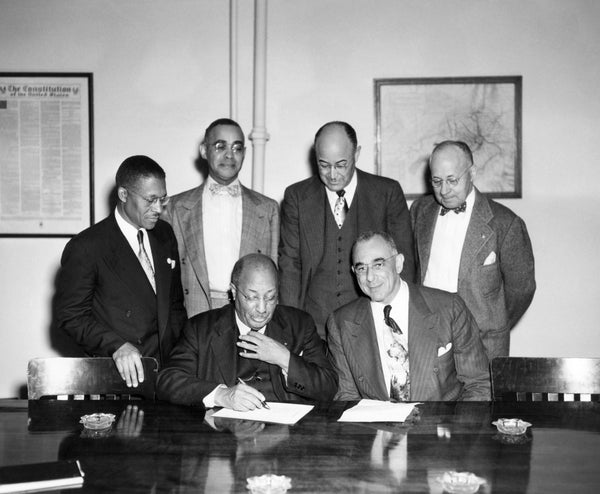 The Colored Citizens Committee of the Roanoke Chamber of Commerce, 1950. Seated at the table are Committee Chairman Dr. Arthur L. James (left) and Dr. Lylburn C. Downing. Standing, from left: Lewis A. Sydnor, W. Harvey Plenty, Dr. Lawrence E. Paxton, and Roanoke Chamber of Commerce Executive Director Benjamin F. Moomaw. Courtesy Historical Society of Western Virginia / #1998.24.060