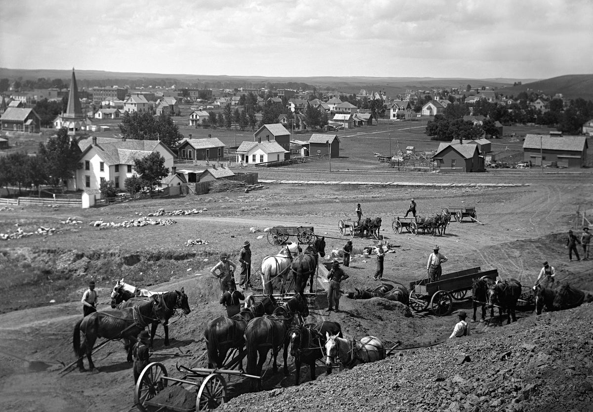 Work crews and equipment cutting a new road near Mandan. Courtesy State Historical Society of North Dakota / #2011-P-002-02198