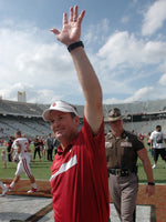 Oklahoma head coach Bob Stoops waves to the fans Saturday, Oct. 8, 2011, as he leaves the Cotton Bowl after the Sooners routed Texas, 55-17. Photo by Jerry Laizure