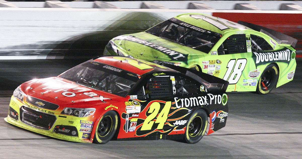 Jeff Gordon passes Kyle Busch in turn four toward the end of the 64th annual Bojangles’ Southern 500 on May 11, 2013, at Darlington Raceway. Gordon finished third in his 700th career start. Courtesy Gavin Jackson / Morning News