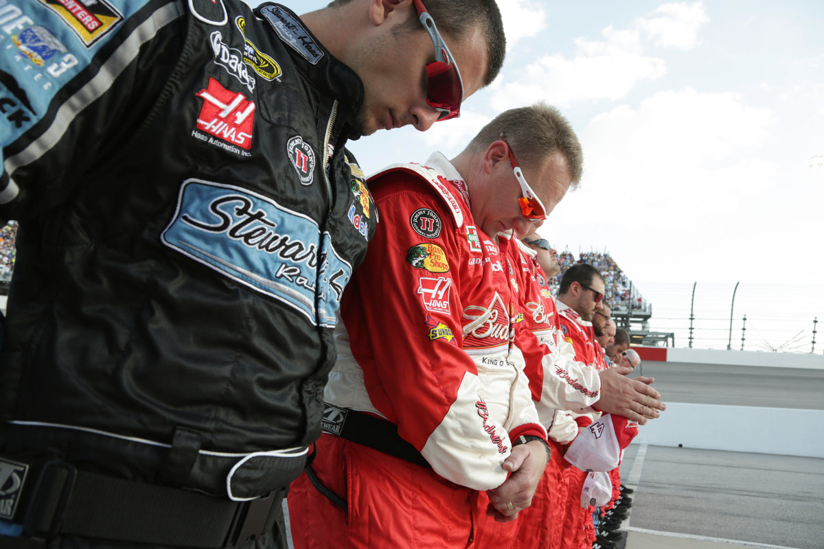 Members of Kevin Harvick’s crew bow their heads in prayer on April 12, 2014, before the Bojangles’ Southern 500 at Darlington Raceway. Harvick went on to win the race. Courtesy John D. Russell / Morning News