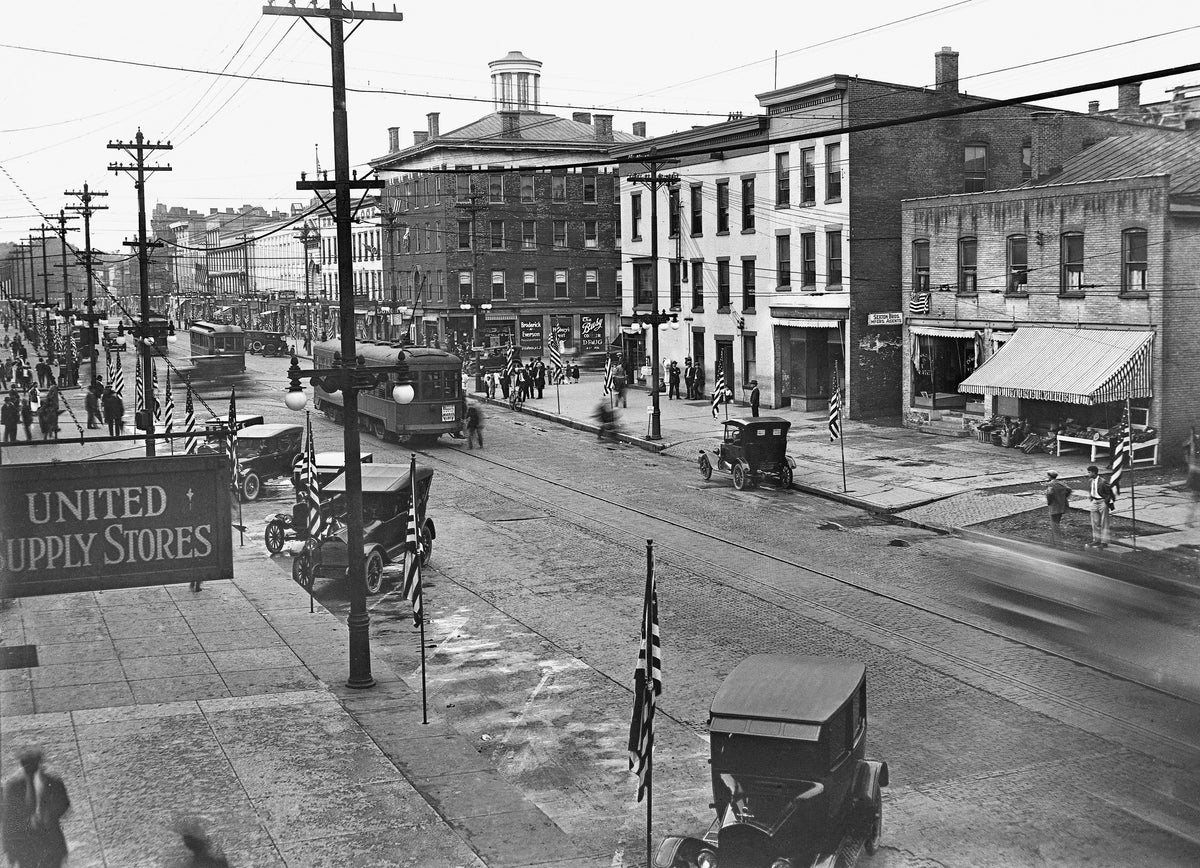 Looking towards the American Corner at the 100 block of East Dominick Street, probably from the marquee of the Strand Theater, circa 1916. The Union Supply Stores was located at 112 East Dominick Street next door to the Strand Theater. One trolley car just went over the track diamond shared with James Street. Courtesy Rome Historical Society / #2018.2.2.329