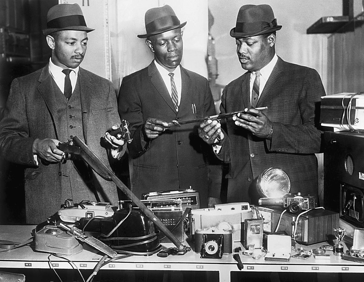 Richmond police officers Christopher Stokes, John W. Harris, and H. L. Coleman reviewing items recovered from a series of North Side burglaries, April 1966. There had been about two dozen residential break-ins in the Washington Park, Ginter Park, and Barton Heights areas in the preceding two months. Police initially recovered about $1,700 in stolen property (equivalent to nearly $14,000 today) and arrested five 14- to 16-year-olds and a 19-year-old in some of the burglaries. Courtesy Richmond Times-Dispatch