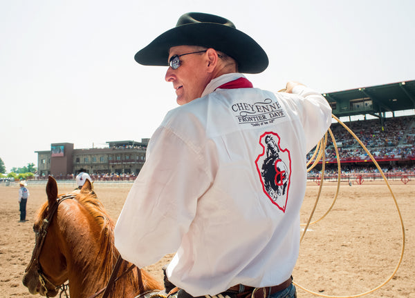 A pick-up man gets ready for the Cheyenne Frontier Days Rodeo to start as he gathers his rope at Frontier Park Arena. Pick-up men ride in the arena as rodeo events happen so they can help riders and contestants get off of their animal safely. Rhianna Gelhart / For the Wyoming Tribune Eagle