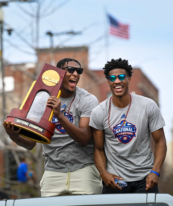 David McCormack holds the NCAA championship trophy as he and teammate Ochai Agbaji enjoy the Jayhawks parade. Reed Hoffmann / Special to The Kansas City Star