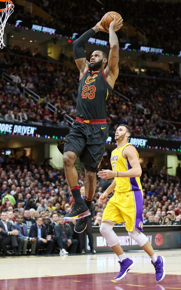 Cleveland Cavaliers forward LeBron James goes airborne for a dunk guarded by Los Angeles Lakers forward Larry Nance Jr. in the first quarter, Dec. 14, 2017, at Quicken Loans Arena. John Kuntz / cleveland.com