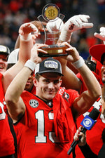 Georgia quarterback Stetson Bennett (13) raises the SEC Championship MVP Trophy after the SEC Championship game. Joshua L. Jones / Athens Banner-Herald