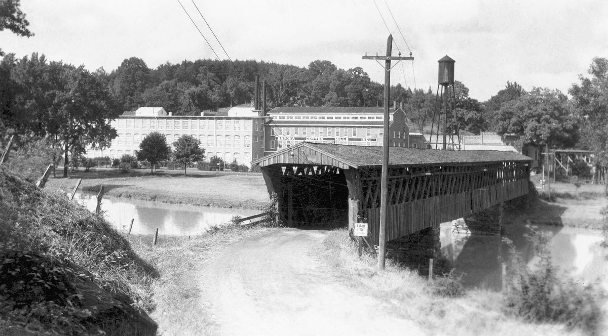 Cedar Falls Covered Bridge over Deep River, 1930. Sapona Cotton Mill is in the background. Courtesy Randolph County Public Library