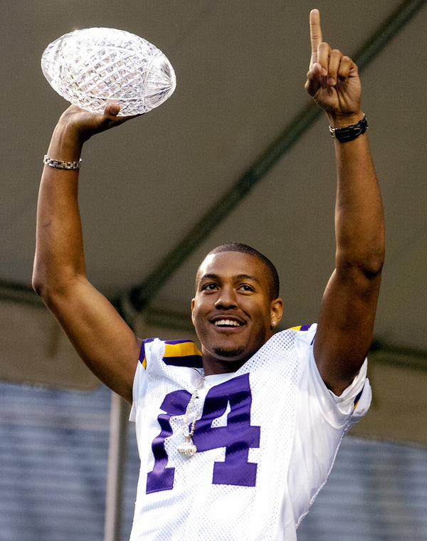 Michael Clayton holds aloft the crystal ball from the BCS national championship trophy on Jan. 24, 2004, at a celebration in Tiger Stadium.  Alex Brandon / The Times-Picayune