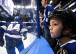 Aiden Galligan, 7, a defenseman who plays for the Ice Storm from Clearwater, watches during warmups before the Tampa Bay Lightning take on the Vancouver Canucks on Jan. 7, 2020, in Tampa. Galligan was the “Thunder Kid” who led the crowd in cheers before the players were introduced. Tampa Bay Times / Dirk Shadd