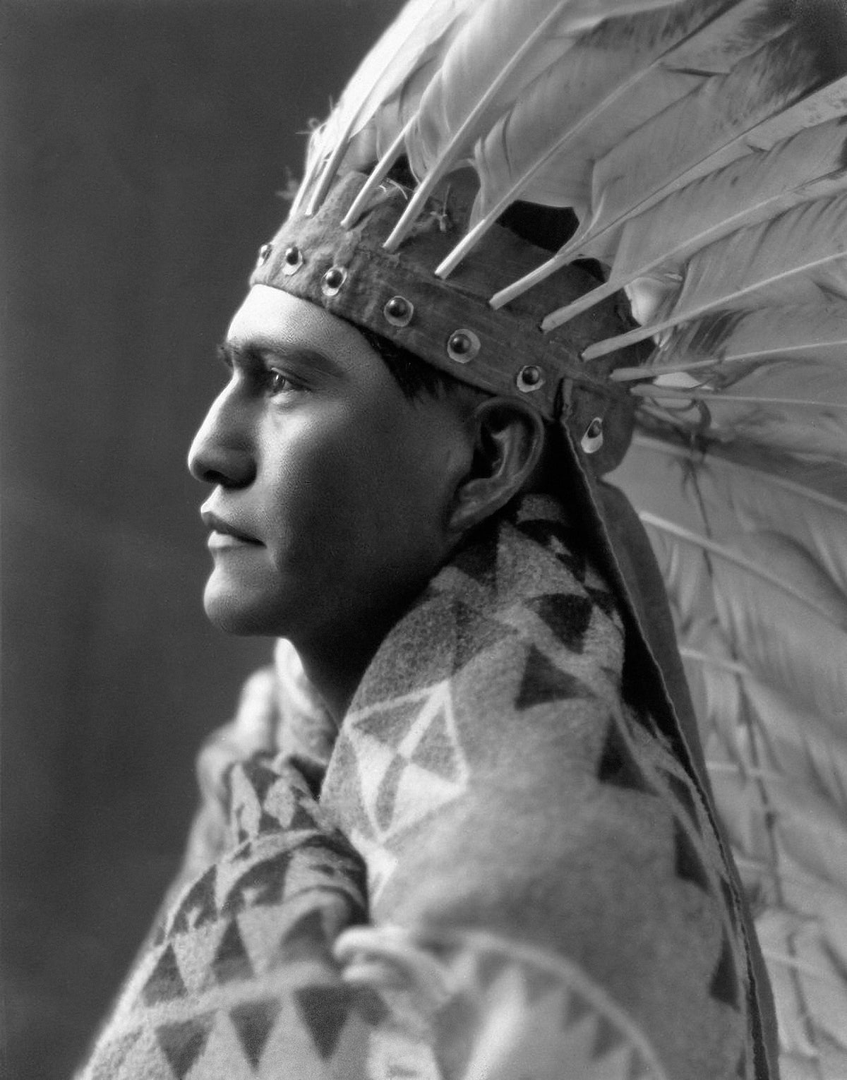 Student John Nick dons a Plains Indian headdress and Pendleton blanket, portraying the image of a handsome young Native scholar at Sherman Institute, 1926. Courtesy Sherman Indian Museum