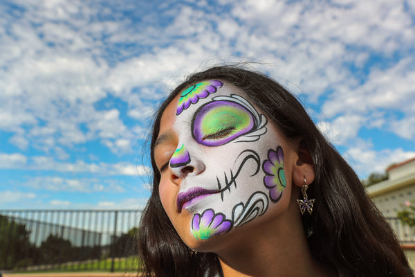 Hailey Flores, 12, keeps her eyes closed while getting her face painted during the Dia de los Muertos celebration at Eternal Hills Memorial Park on Nov. 2, 2019, in Oceanside. Hayne Palmour IV / The San Diego Union-Tribune