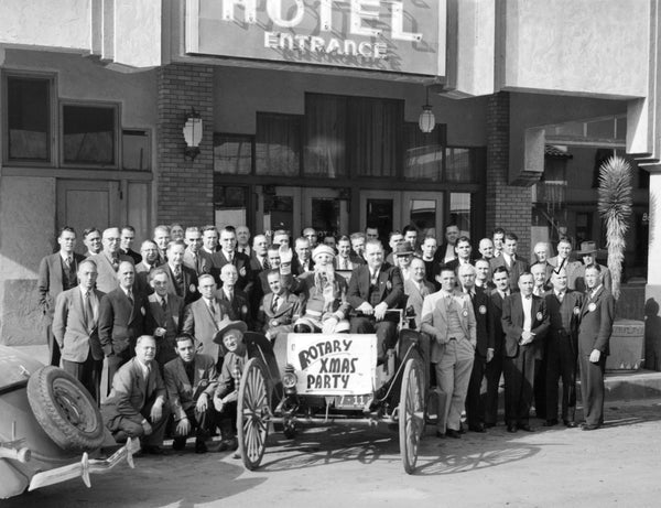 Rotary Club members at a Christmas party in Las Vegas, 1940. The group is in front of the Apache Hotel. Club President A.C. Grant is seated beside a waving Santa Claus in an automobile bearing a sign that reads: "Rotary Xmas Party." Secretary Bryan L. Bunker is standing second from the right in the first row. This photo was taken from a time capsule in the cornerstone of the Union Pacific Railroad station located in Las Vegas. Courtesy Rotary Club of Las Vegas
