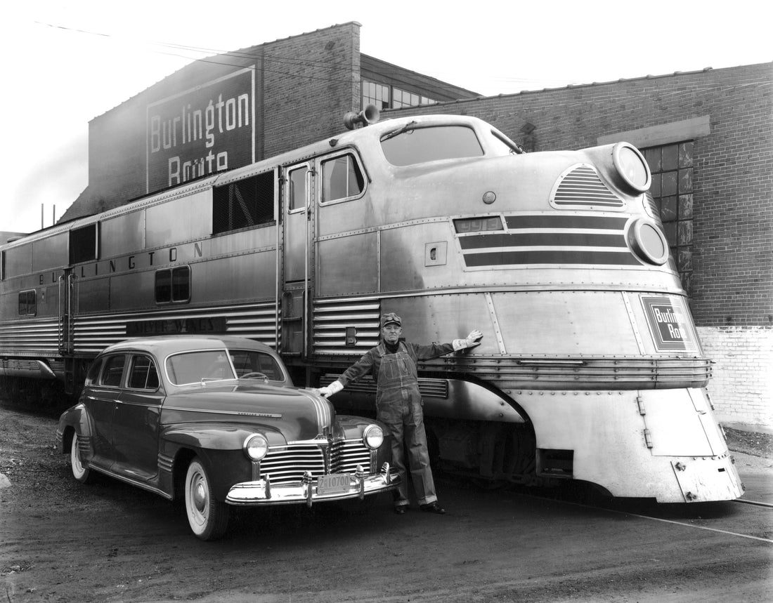 An engineer stands between a Chicago, Burlington & Quincy Railroad Silver Streak Zephyr engine and a new Pontiac automobile near the railroad facilities in Lincoln, November 23, 1940. Courtesy Nebraska State Historical Society / #RG2183.PH001940-001123-1