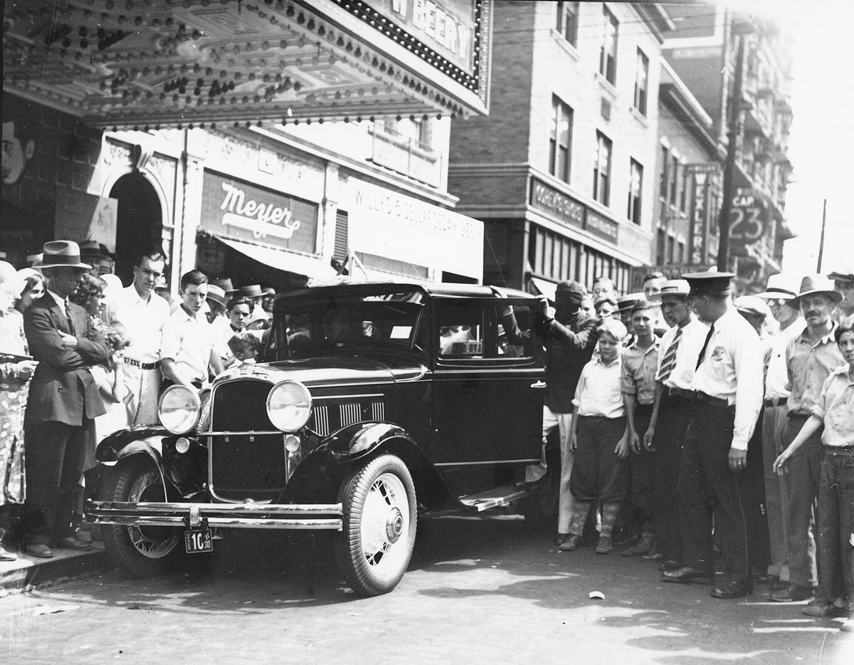 A crowd gathers to see Willy's Delux Sedan in front of Orpheum Theatre, circa 1932.