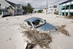 A car is buried in sand at Carolina Avenue and Long Beach Boulevard in the Holgate section of Long Beach Island. Noah K. Murray / The Star-Ledger