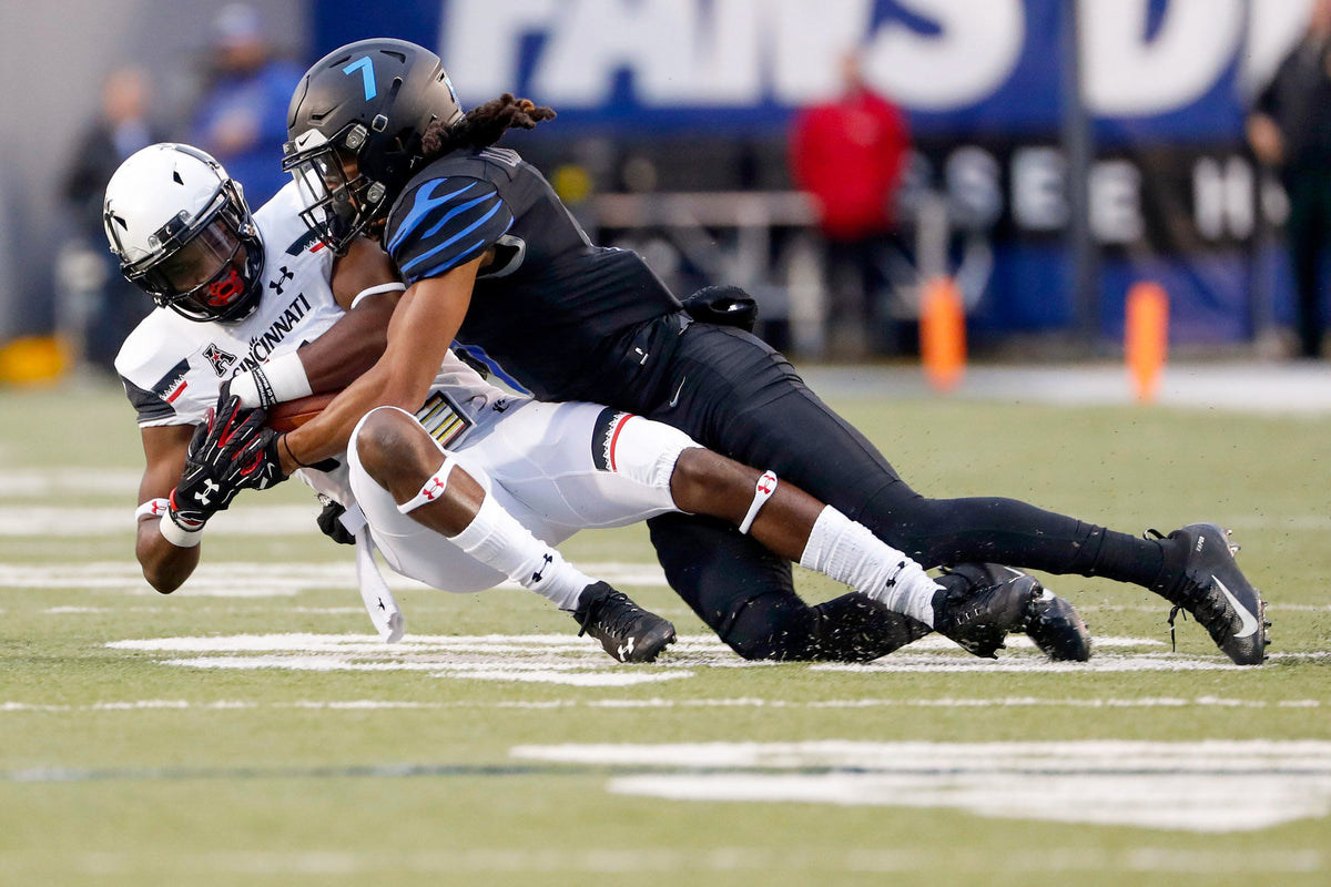 Memphis Tigers defensive back Chris Claybrooks wraps up Cincinnati’s Thomas Geddis. Courtesy Max Gersh / The Commercial Appeal