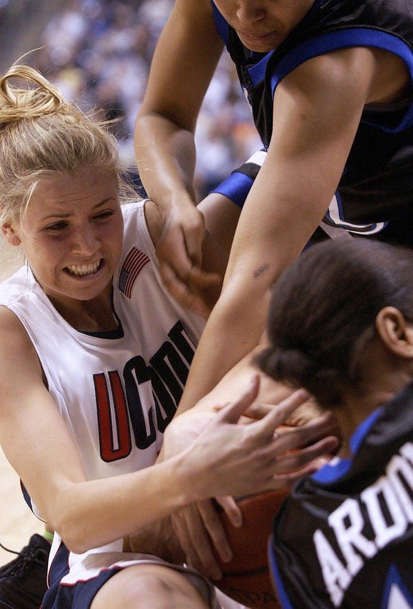 UConn’s Ann Strother fights Seton Hall’s Leslie Ardon, bottom and Asia Carroll, for the ball, during a 2003 game at Gampel Pavilion. Sean D. Elliot / The Day