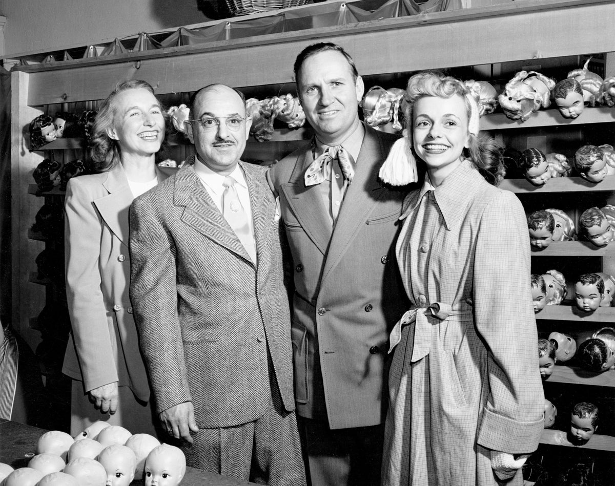Violet Gradwohl, Harry Gradwohl, Gene Autry, and Terri Lee Schrepel pause for a group photo at the Terri Lee Doll Company factory in Lincoln, circa 1950. Courtesy Nebraska State Historical Society / #RG5812.PH0-000042
