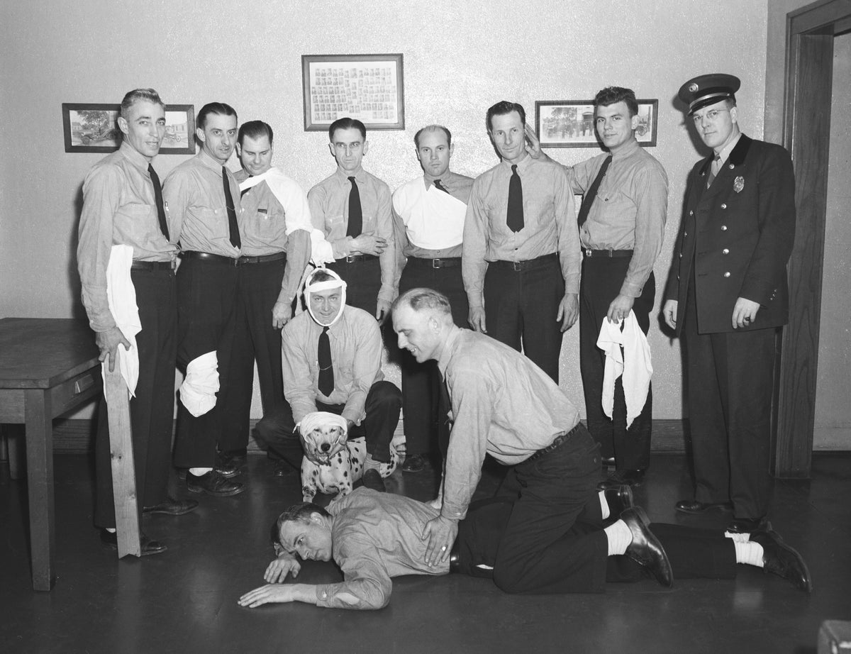 Members of the Lancaster County Red Cross show off bandaging techniques during a first aid demonstration at the No. 2 Fire Barn, February 6, 1947. Even the dog is wearing bandages. Courtesy Nebraska State Historical Society / #RG2183.PH001947-000206-1