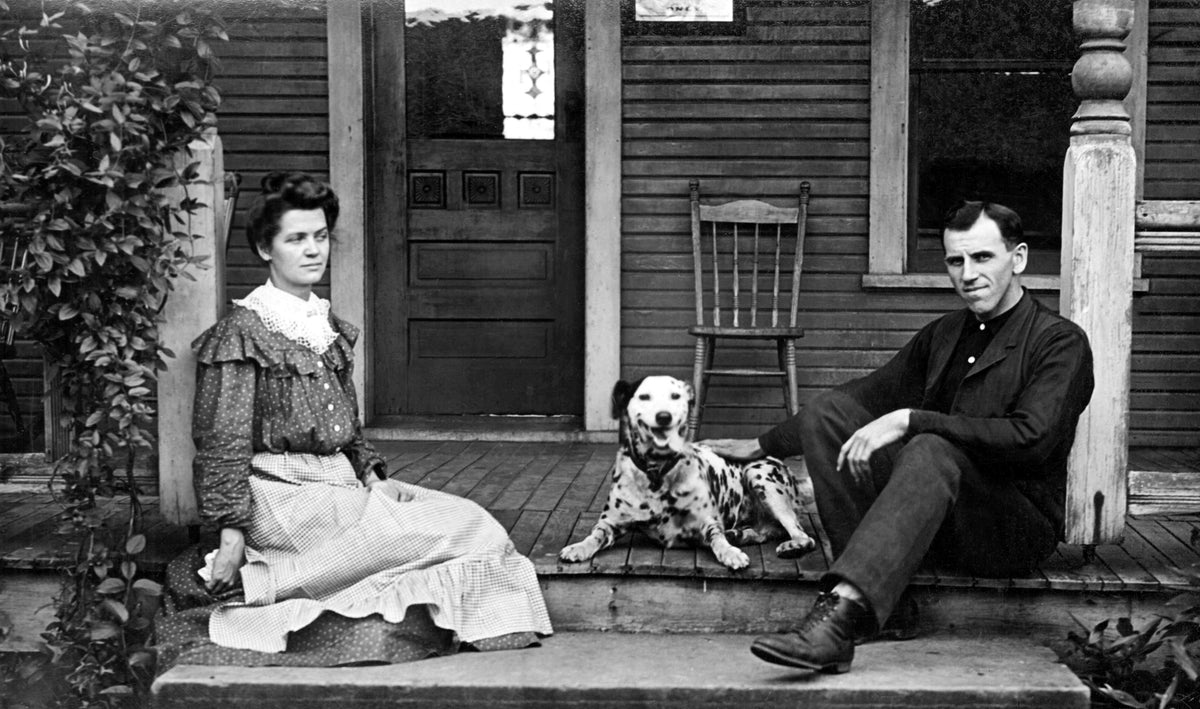 A couple and their dog seated on their front porch in Zoar, circa 1900. Courtesy Ohio History Connection / #AL05971