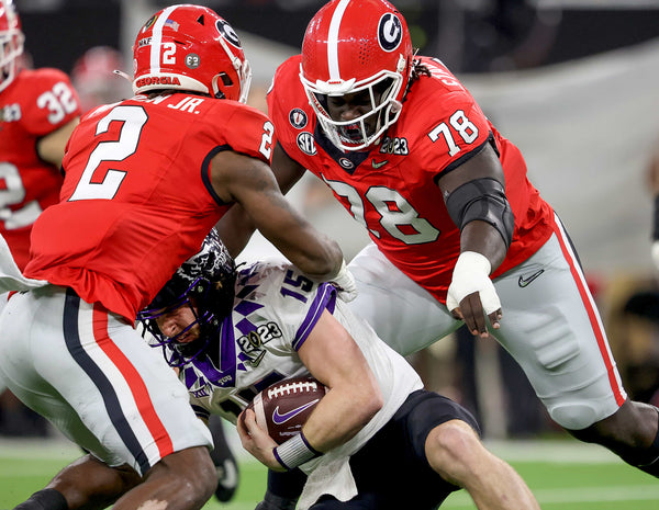 TCU quarterback Max Duggan is double teamed by Georgia middle linebacker Smael Mondon, left, and nose tackle Nazir Stackhouse at the 2023 College Football Playoff National Championship on Jan. 9, 2023, at SoFi Stadium in Inglewood, Calif.  (Amanda McCoy / Fort Worth Star-Telegram)