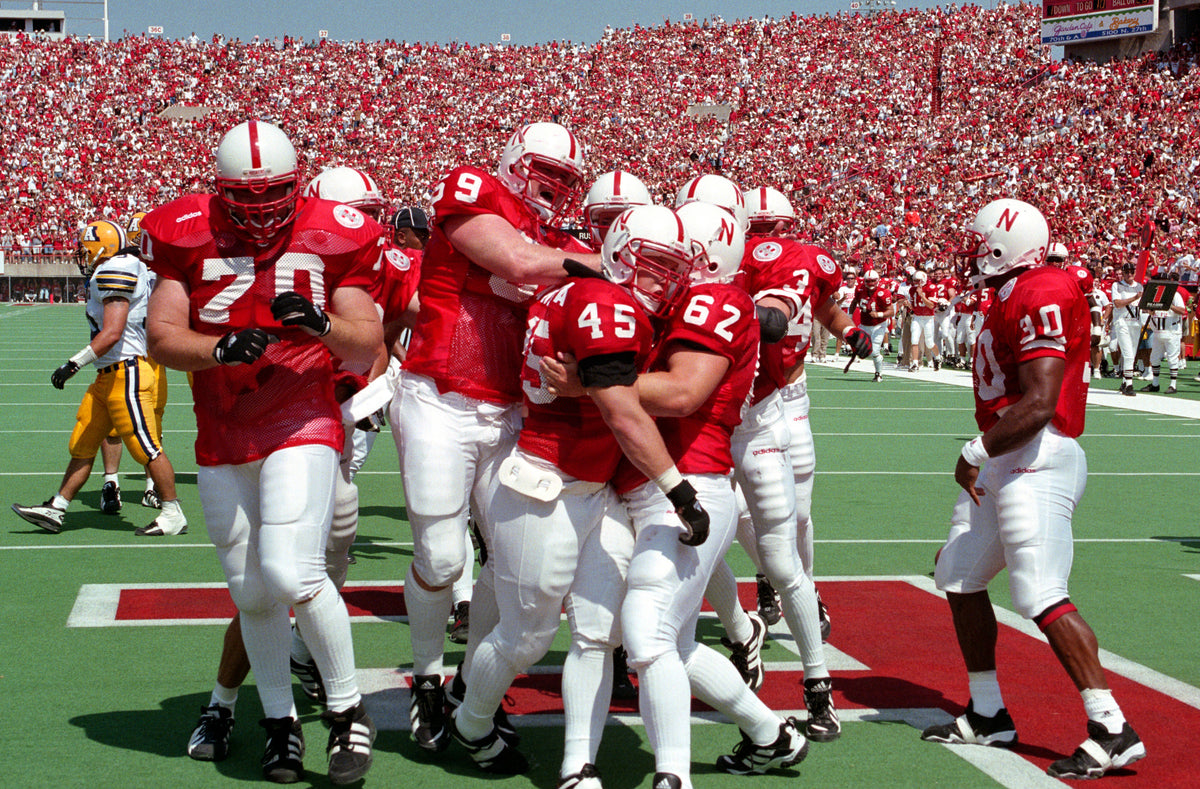 Teammates celebrate after Joel Makovicka scores one of his two touchdowns against Akron. Courtesy Lincoln Journal Star