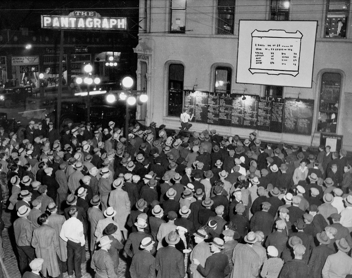 The Pantagraph updates a bulletin board for the 1934 election as a crowd looks on, Bloomington. Courtesy of the McLean County Museum of History
