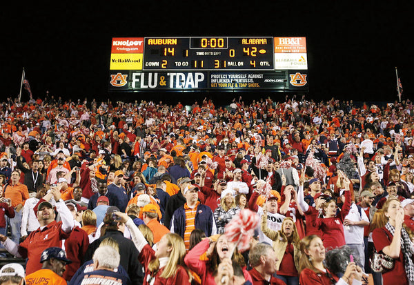 Alabama fans celebrate the teams victory over Auburn at Jordan-Hare Stadium.